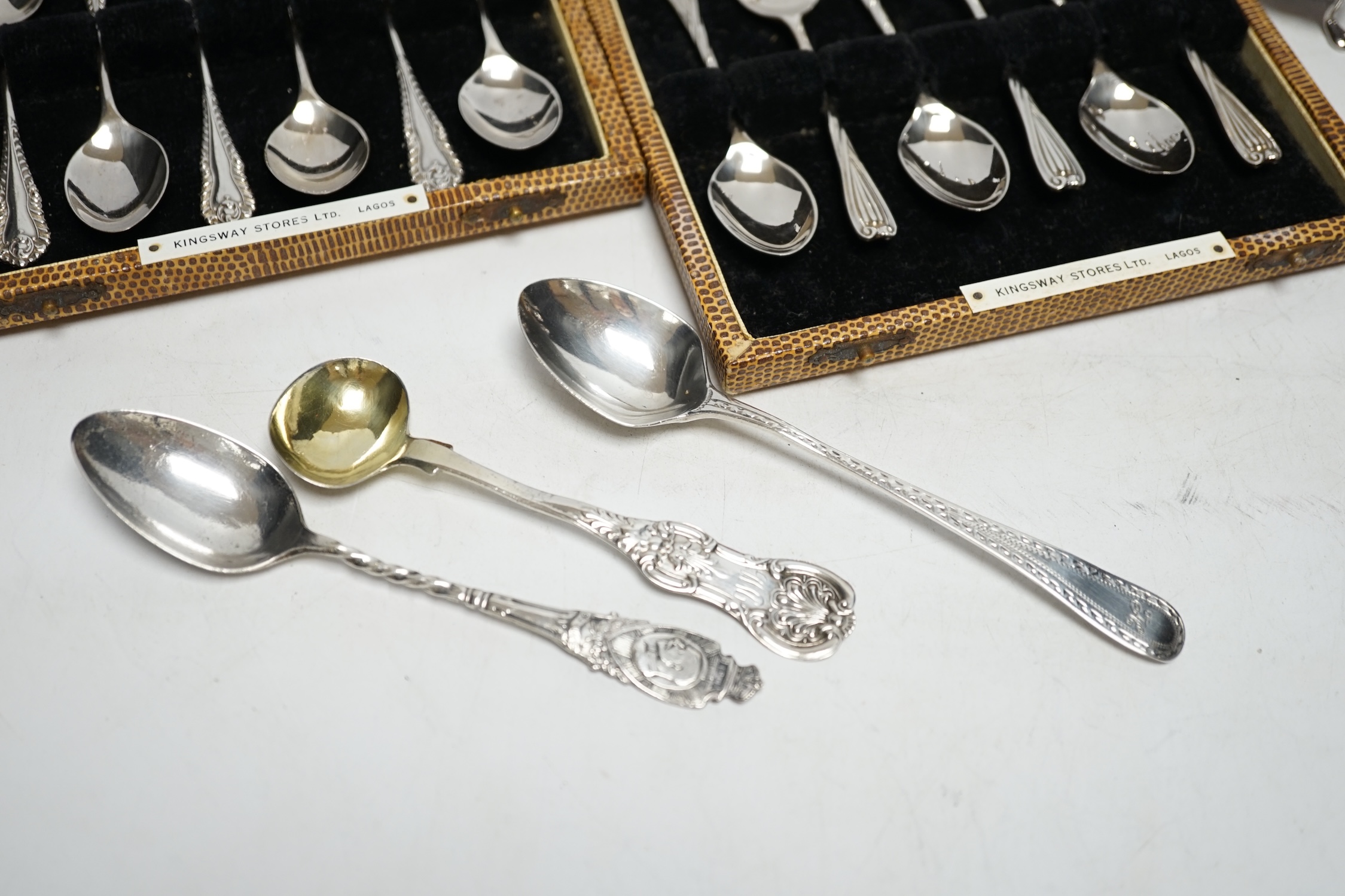Two cased sets of six silver coffee spoons, a set of four silver condiments, two silver napkin rings, silver toastrack, etc.